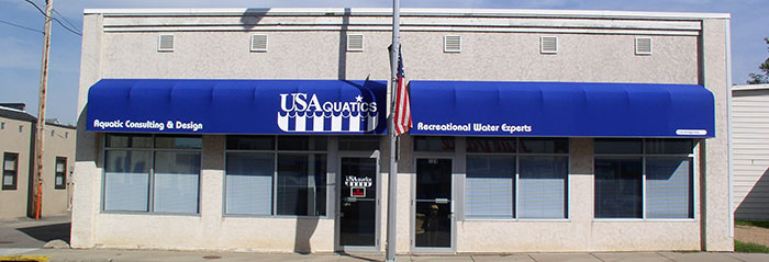 commercial building with a blue canvas awning